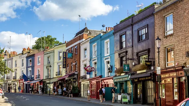 Street view of colourful houses and shops in Notting Hill W11, London